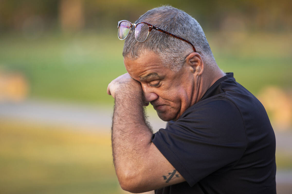 Carlos Gurri wipes away tears while visiting the grave of former FBI Special Agent John Bailey ...