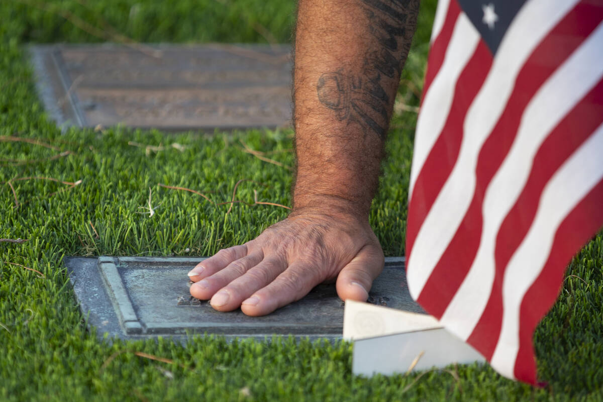 Carlos Gurri cleans the grave of former FBI Special Agent John Bailey at Palm Eastern Mortuary, ...