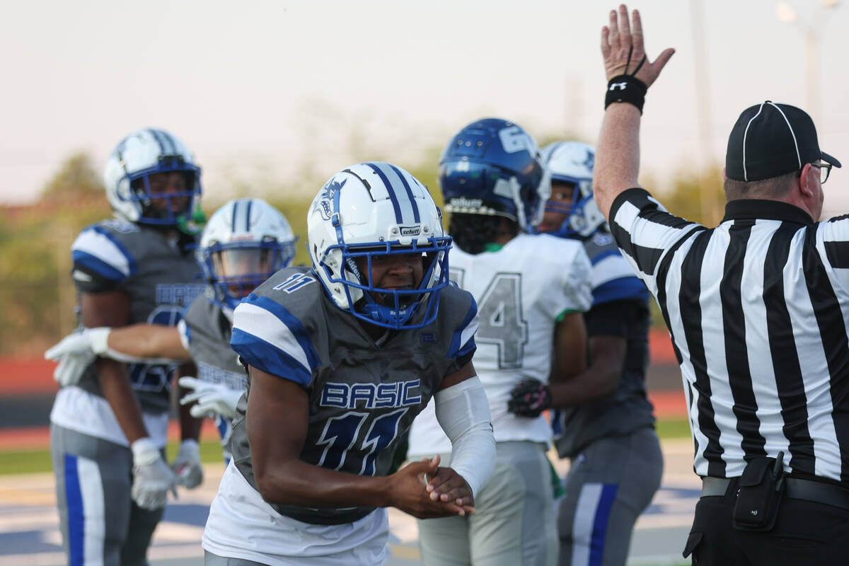 Basic’s Jacori Turner (11) celebrates after the Wolves recovered a fumble during a high ...