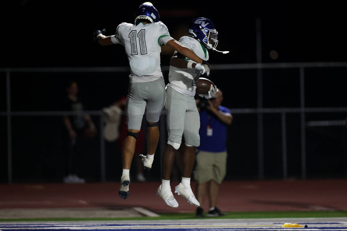 Green Valley’s Aiden Adams (11) and Evan Williams (2) celebrate their touchdown during t ...