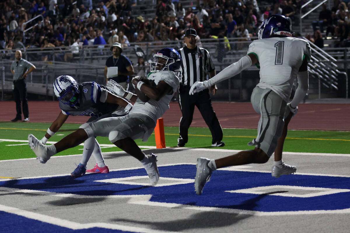 Green Valley’s Evan Williams catches a touchdown pass against Basic’s Chris Smith ...