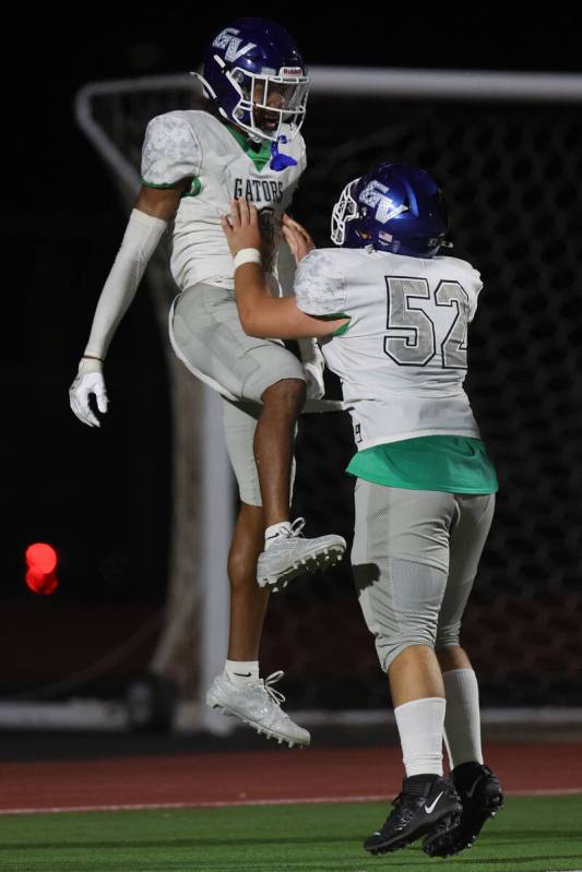 Green Valley’s Trey Glasper (1) and Mason Hurd (52) celebrate their touchdown during the ...