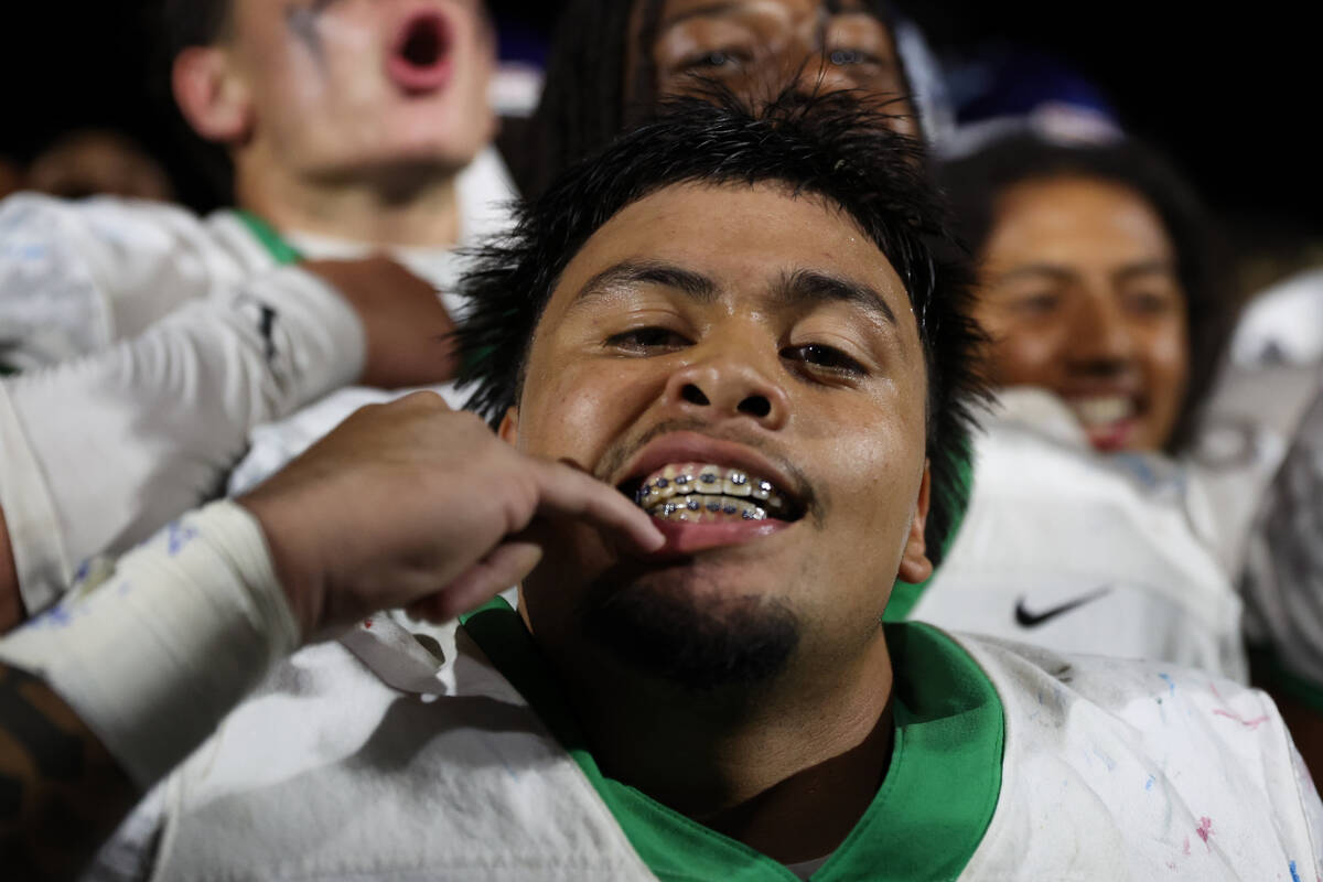 Green Valley’s No. 22 shows off his braces after winning a high school football game aga ...