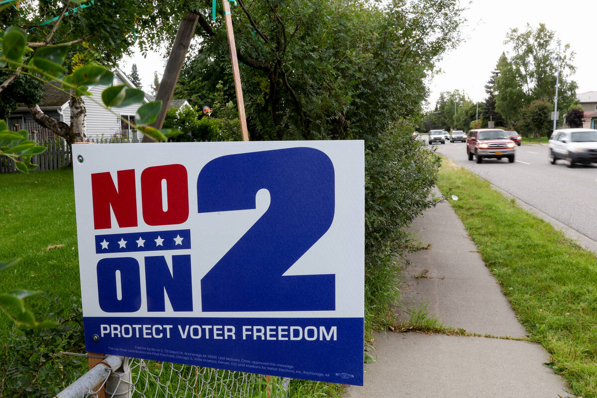 An Anchorage resident’s fence hangs a “No On 2” sign on Tuesday, Aug. 27, ...