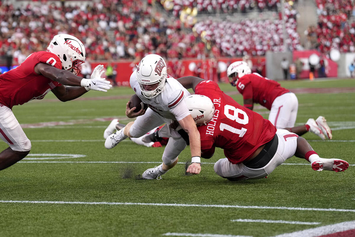 UNLV quarterback Matthew Sluka (3) is stopped short of the goal line by Houston defensive linem ...