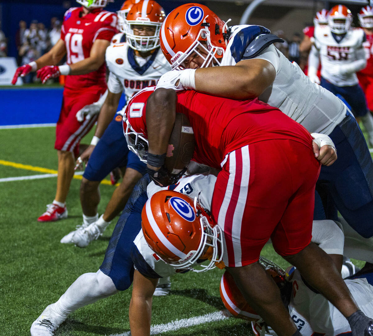 Mater Dei running back Jordon Davison (0) is swarmed by Bishop Gorman defenders during the seco ...