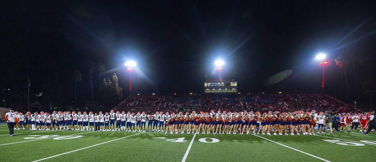 Bishop Gorman players and cheerleaders come together on the field after a loss to Mater Dei fol ...