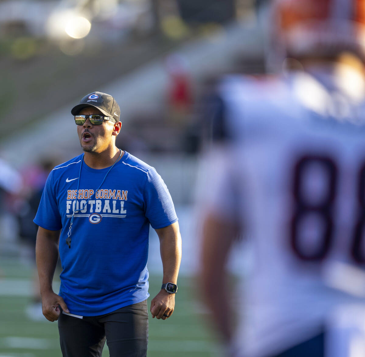 Bishop Gorman head coach Brent Browner pumps up his team as they warm up to face Mater Dei in t ...