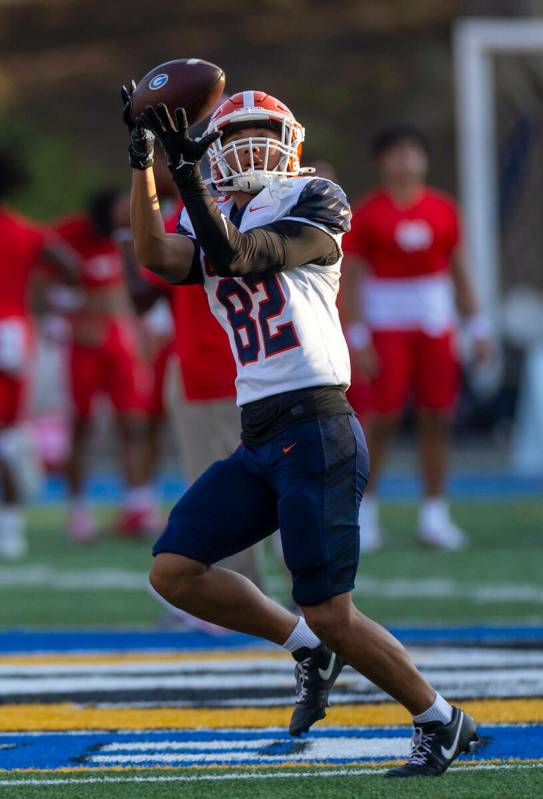 Bishop Gorman wide receiver Zyren Menor (82) catches a pass as they warm up to face Mater Dei i ...