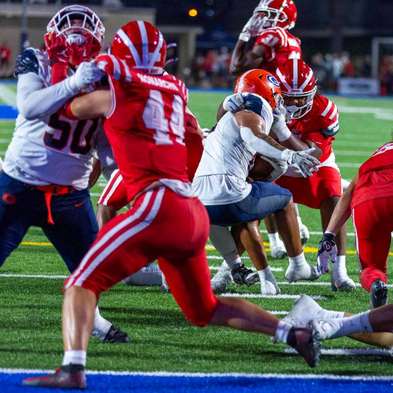 Bishop Gorman running back Jonathan Coar (21) is stopped on his way to the end zone as a Mater ...