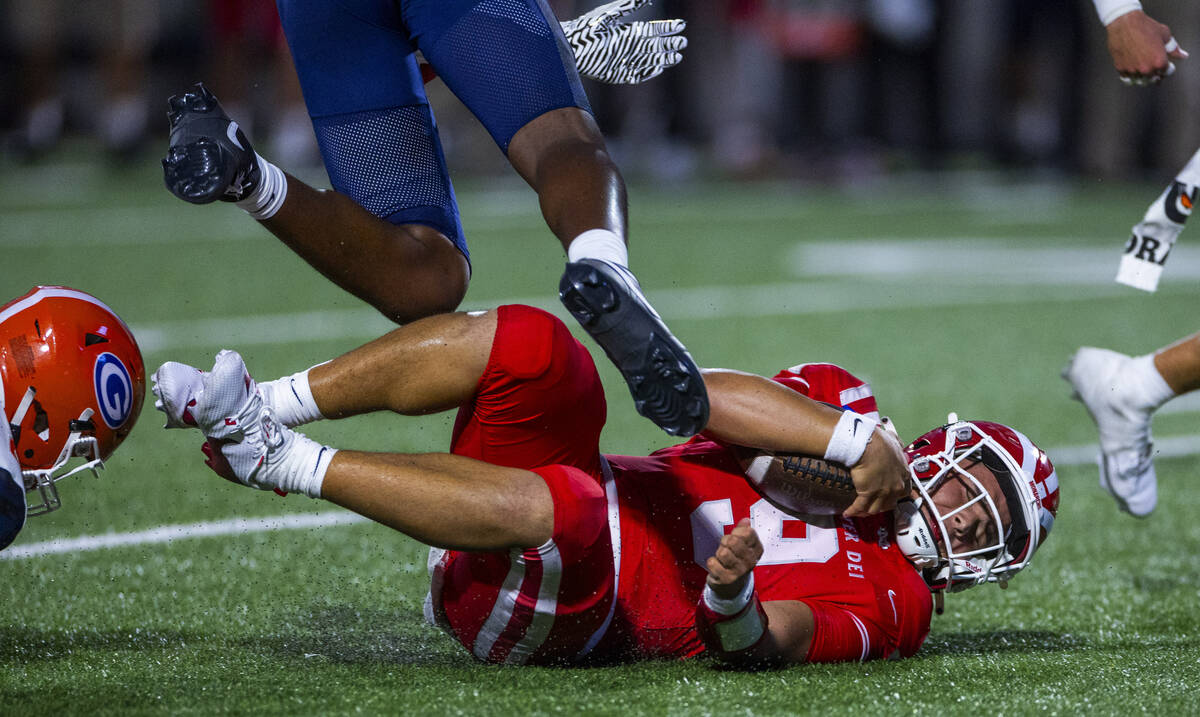 Mater Dei quarterback Ashton Beierly (9) slides down after a run as a Bishop Gorman defender ju ...