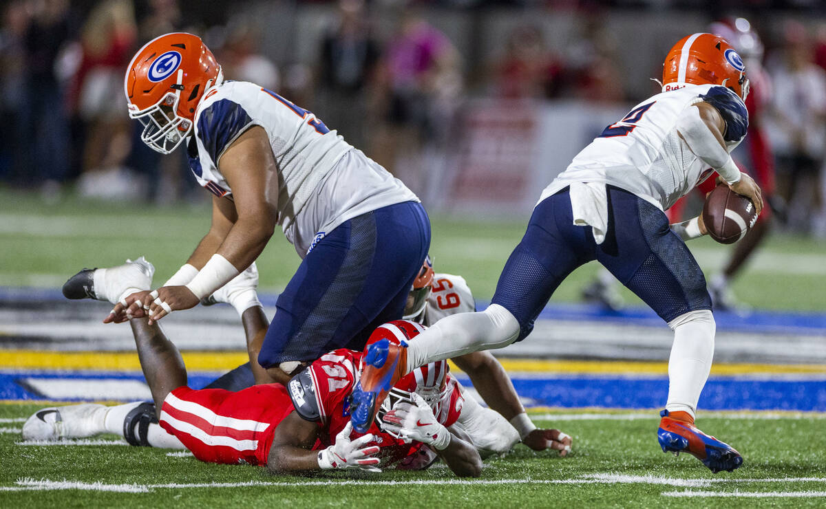 Bishop Gorman quarterback Melvin Spicer IV (2) breaks free from a leg tackle against Mater Dei ...