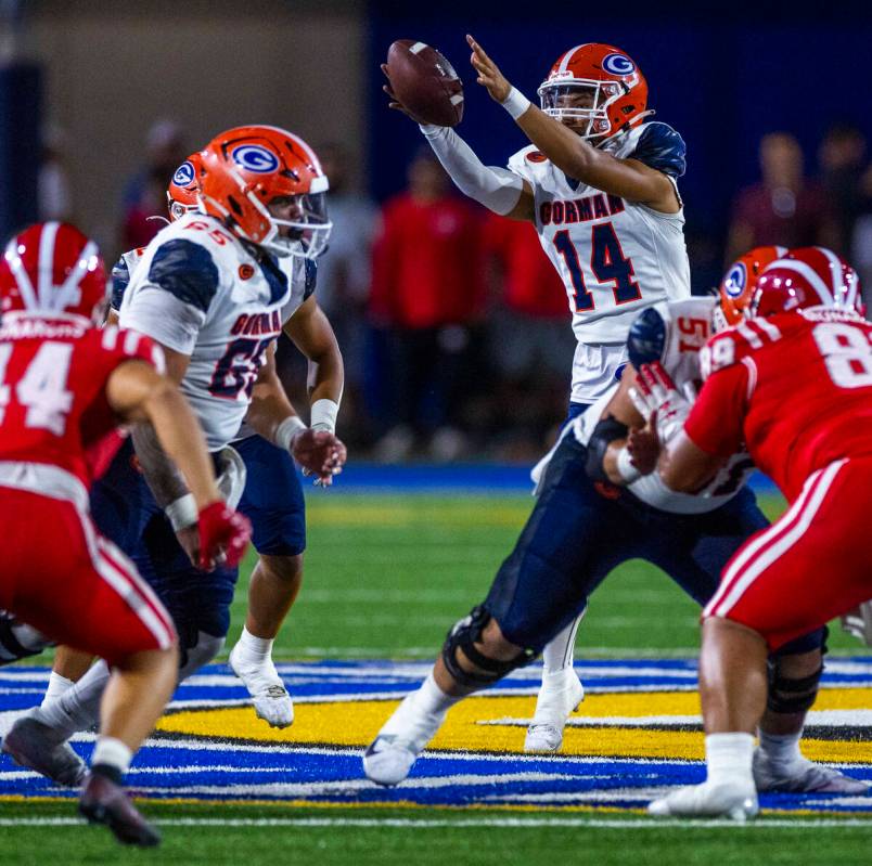 Bishop Gorman quarterback Maika Eugenio (14) lreaches for an errant snap against Mater Dei duri ...