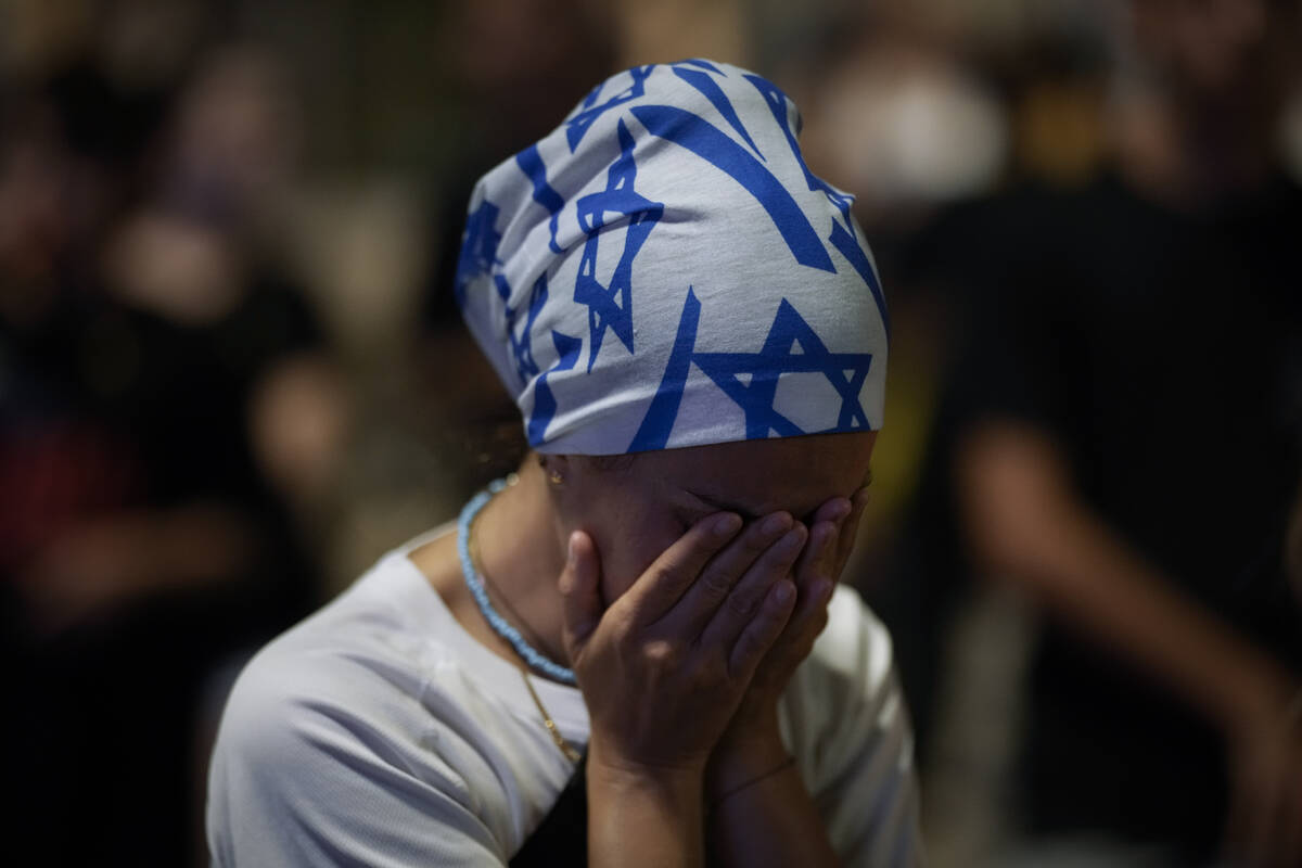 A demonstrator reacts during a protest against Prime Minister Benjamin Netanyahu's government a ...