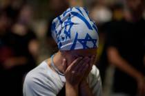 A demonstrator reacts during a protest against Prime Minister Benjamin Netanyahu's government a ...