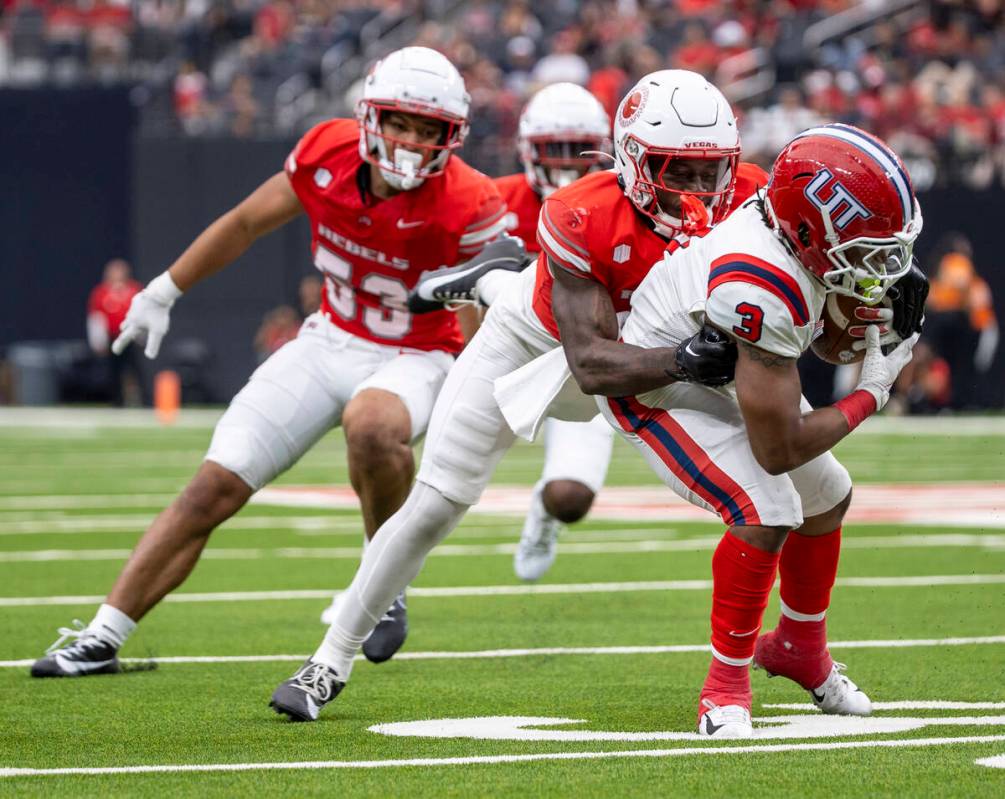 UNLV defensive back Jett Elad (9) tackles Utah Tech running back Chris Street (3) during the co ...