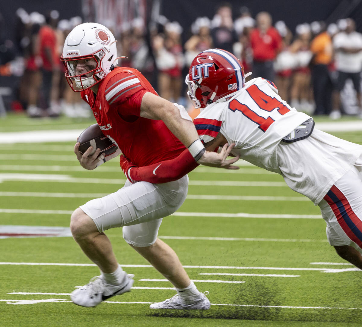 UNLV quarterback Matthew Sluka (3) avoids Utah Tech linebacker Elijah Wood (14) during the coll ...