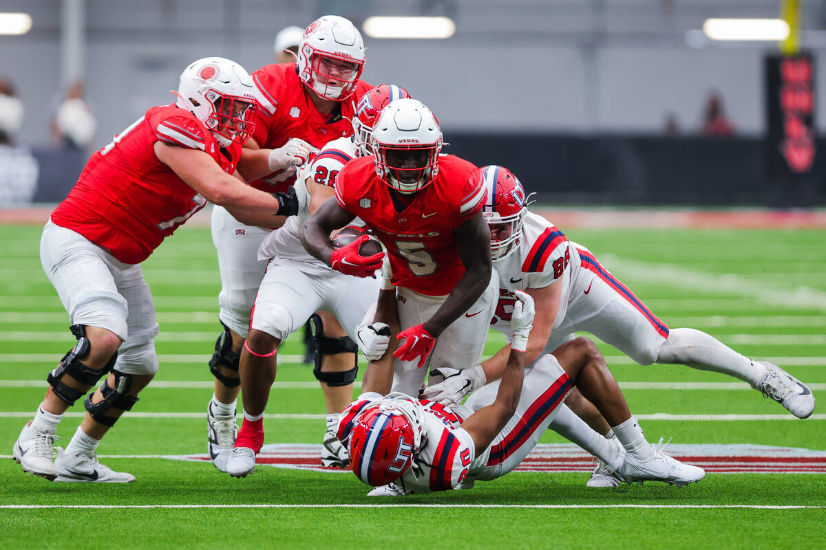 UNLV running back Greg Burrell (5) powers through Utah Tech defense during an NCAA football gam ...