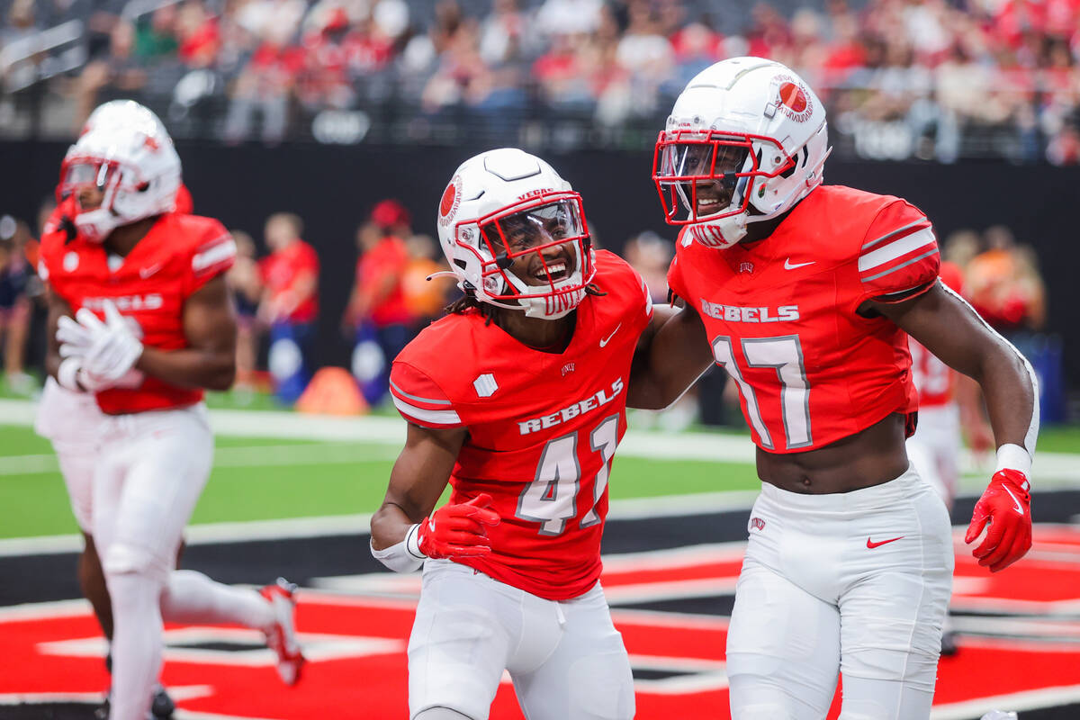 UNLV defensive back La'Vario Wiley (17) celebrates with teammate Rashod Tanner (41) during an N ...