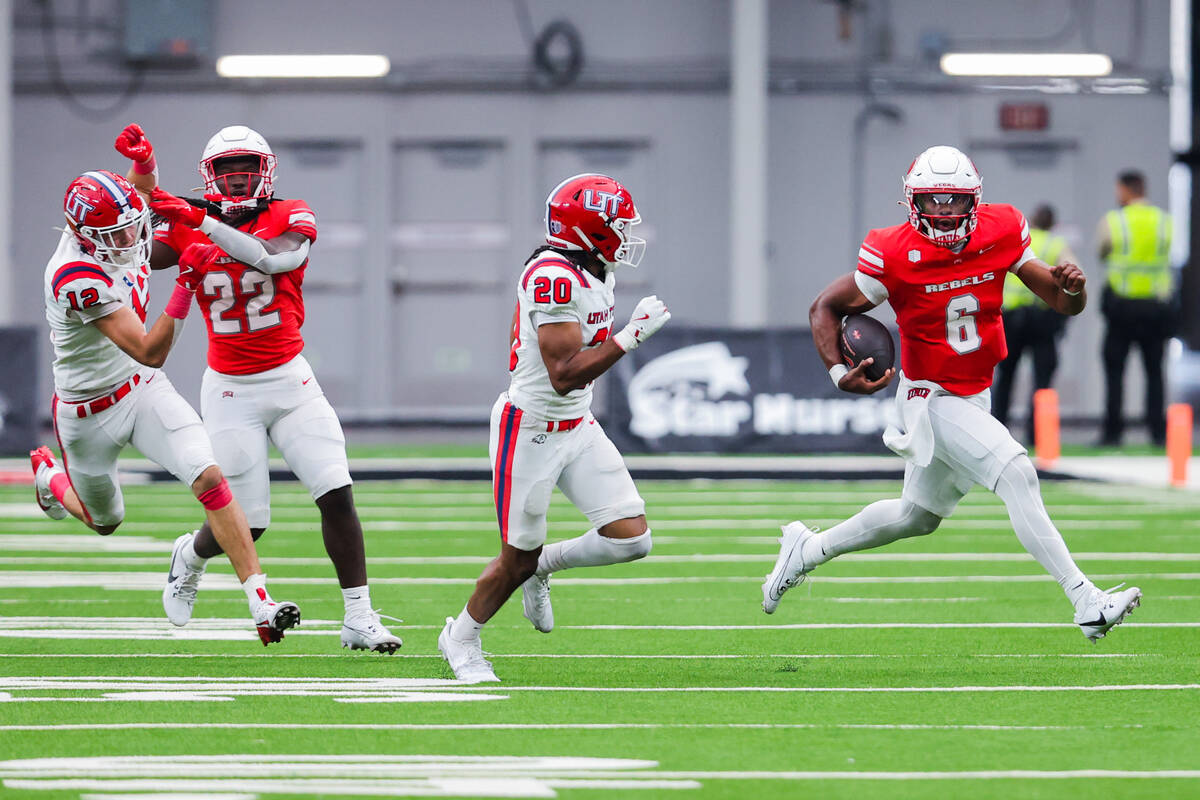 UNLV quarterback Hajj-Malik Williams (6) scrambles with the ball during an NCAA football game b ...