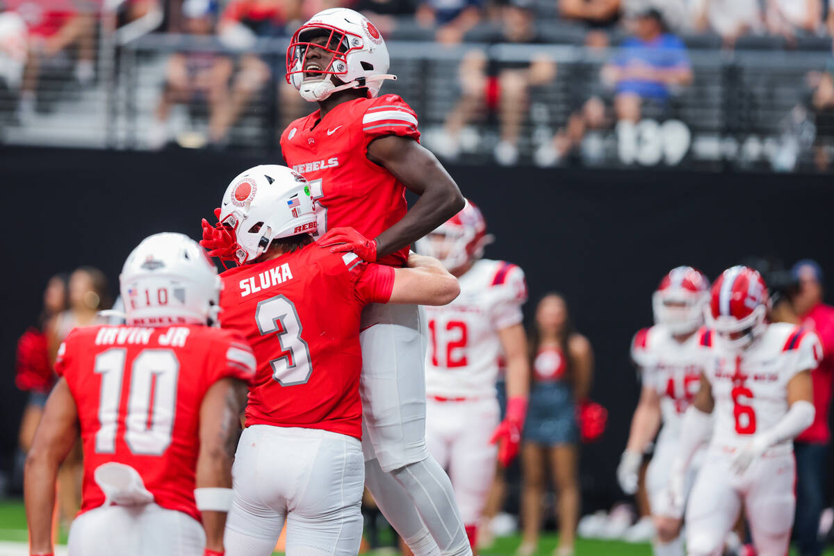 UNLV running back Greg Burrell (5) and quarterback Matthew Sluka (3) celebrate a touchdown by S ...