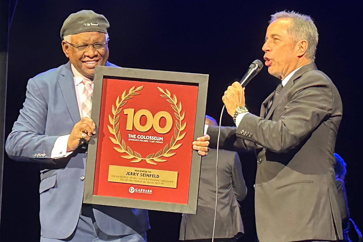 George Wallace presents Jerry Seinfeld with a plaque commemorating Seinfeld's 100th performance ...