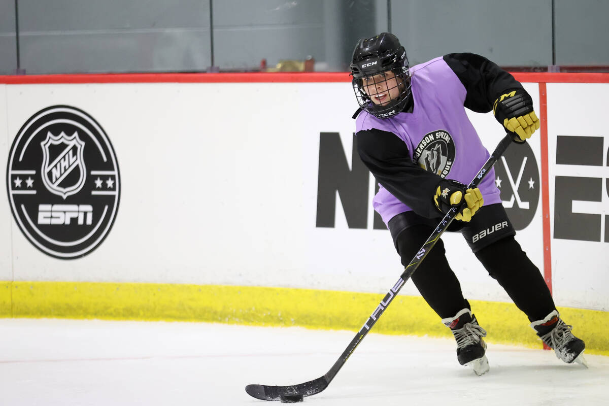 A Golden Knights 14U Girls team player skates with the puck during practice at America First Ce ...