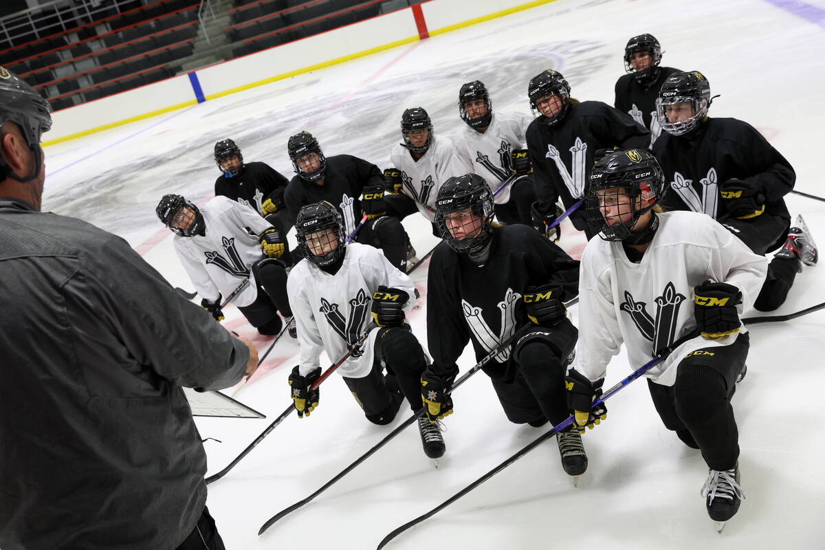 Vegas Jr. Golden Knights 14U Girls team players listen to their coach during practice at Americ ...