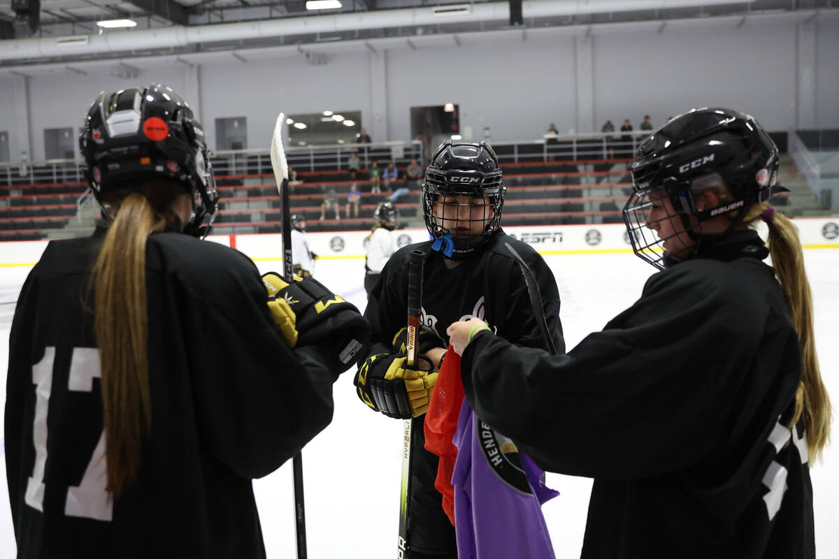 Vegas Jr. Golden Knights 14U Girls team players suit up for drills during practice at America F ...