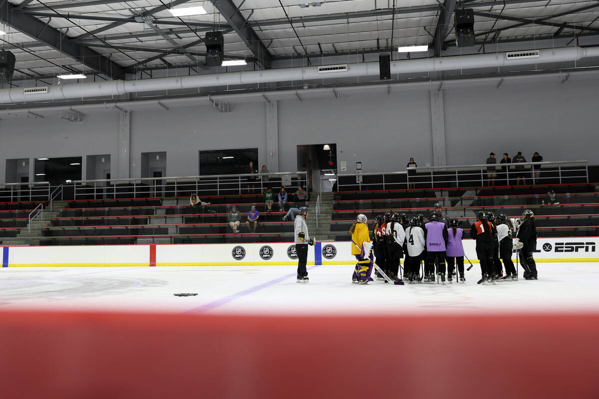 Vegas Jr. Golden Knights 14U Girls team players gather on the ice during practice at America Fi ...