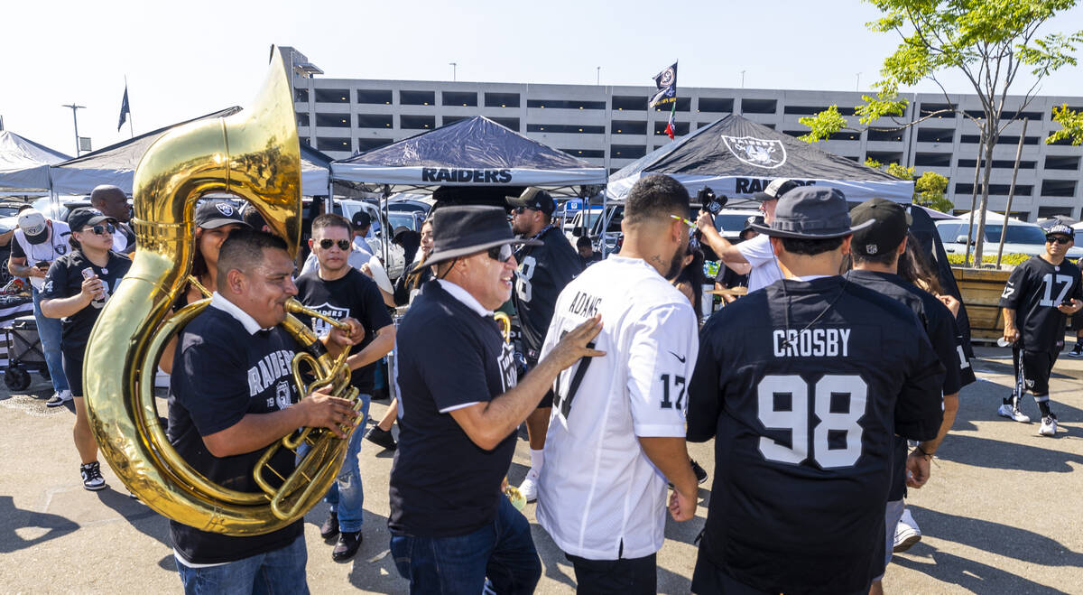 A band plays as fans dance in the tailgate area before the Raiders face the Los Angeles Charger ...