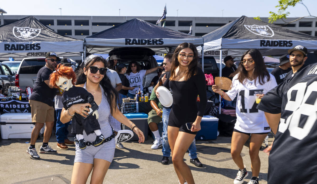 Fans dance as Banda Puro Zacatecas plays in the tailgate area before the Raiders face the Los A ...