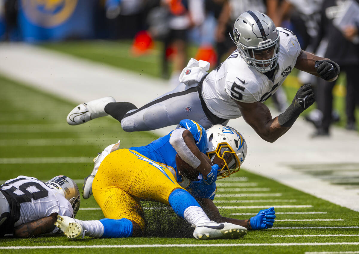 Raiders linebacker Divine Deablo (5) soars past Los Angeles Chargers running back J.K. Dobbins ...