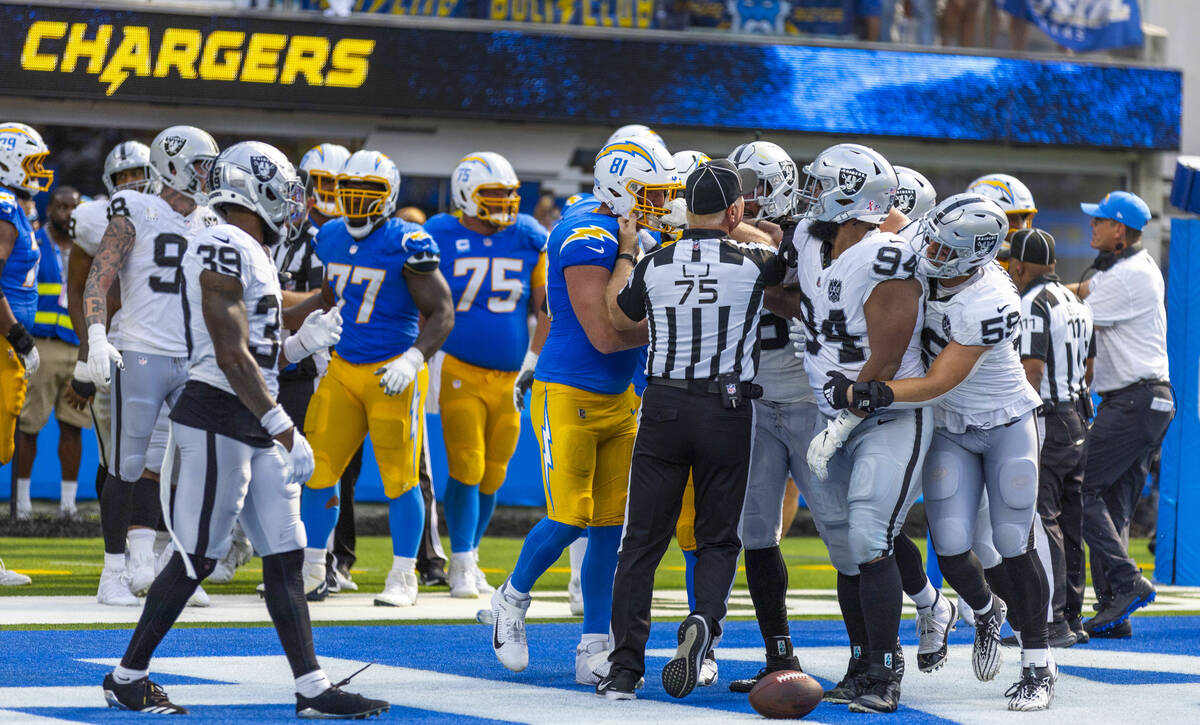 Raiders and Los Angeles Chargers players scrap in the end zone after a two-point conversion dur ...