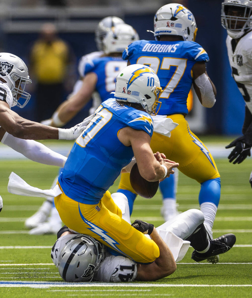 Raiders linebacker Robert Spillane (41) sacks Los Angeles Chargers quarterback Justin Herbert ( ...