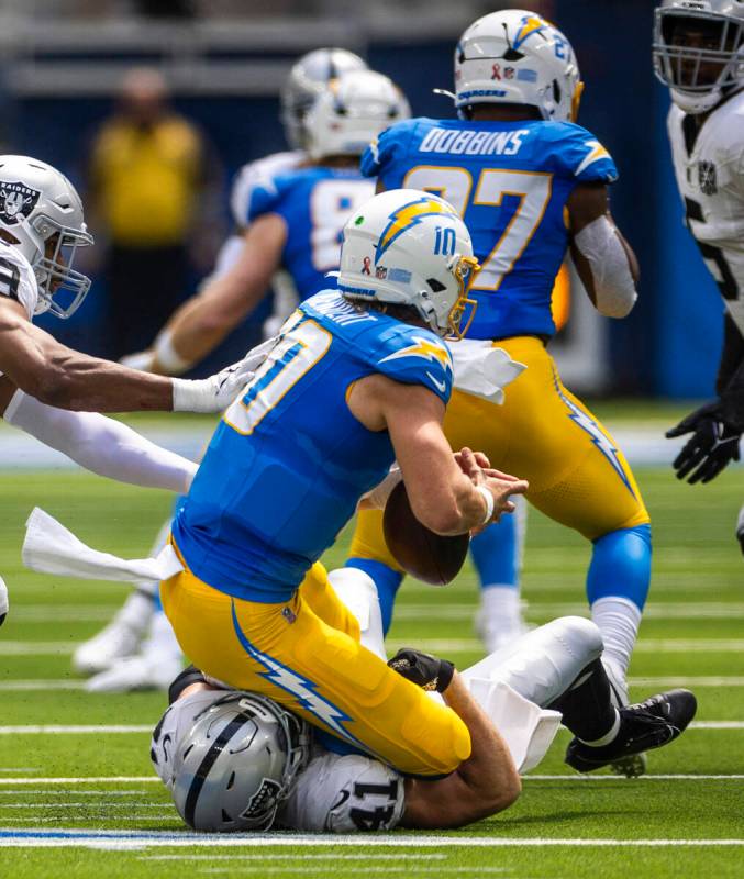 Raiders linebacker Robert Spillane (41) sacks Los Angeles Chargers quarterback Justin Herbert ( ...