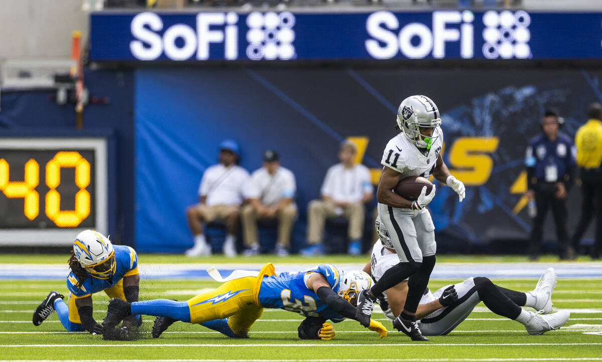 Raiders wide receiver Tre Tucker (11) breaks a tackle attempt by Los Angeles Chargers safety A ...