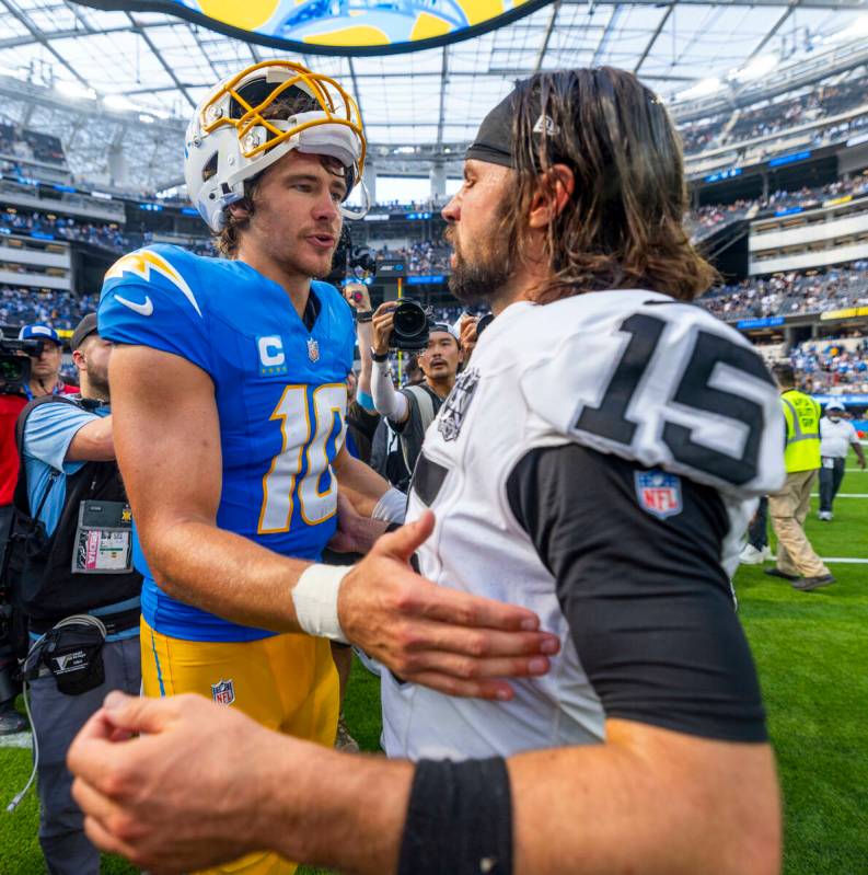 Raiders quarterback Gardner Minshew (15) and Los Angeles Chargers quarterback Justin Herbert (1 ...