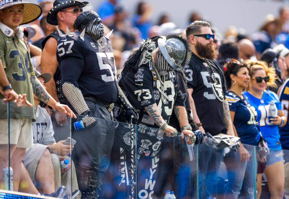 Raiders fans stand dejected as the Los Angeles Chargers score a late touchdown during the secon ...