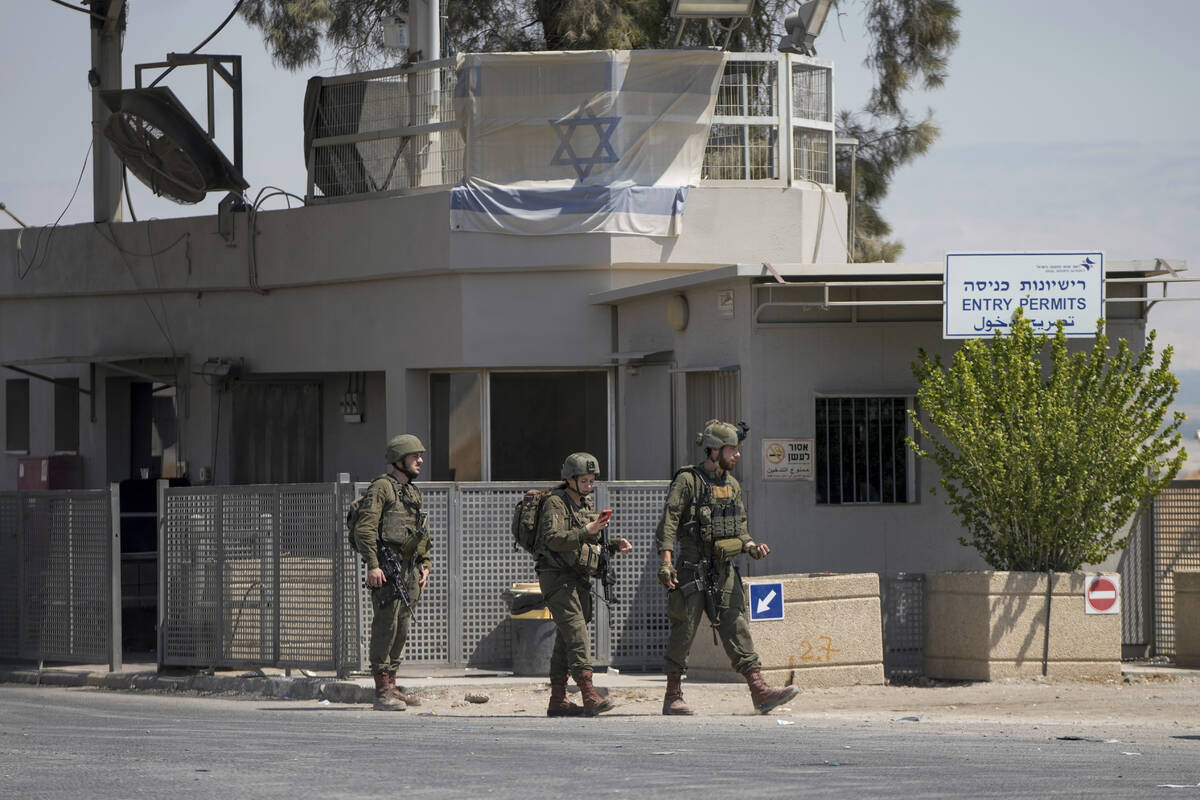 Israeli soldiers stand guard near the site of a deadly shooting attack where Israeli officials ...