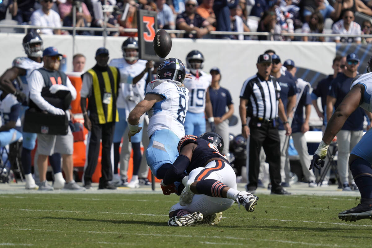 Tennessee Titans quarterback Will Levis throws an interception for a Bears' touchdown off press ...