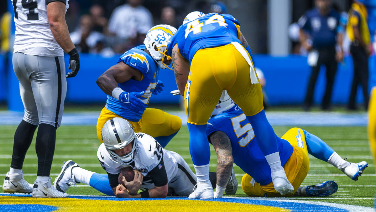 Raiders quarterback Gardner Minshew (15) is sacked by Los Angeles Chargers linebacker Khalil Ma ...