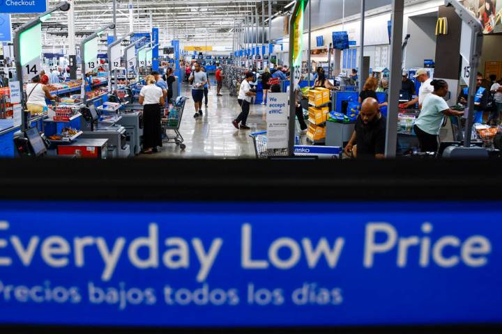 Customers use self check out at a Walmart Superstore in Secaucus, New Jersey, July 11, 2024. (A ...