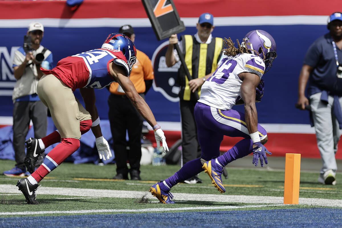 Minnesota Vikings running back Aaron Jones (33) runs for a touchdown during the first half of a ...