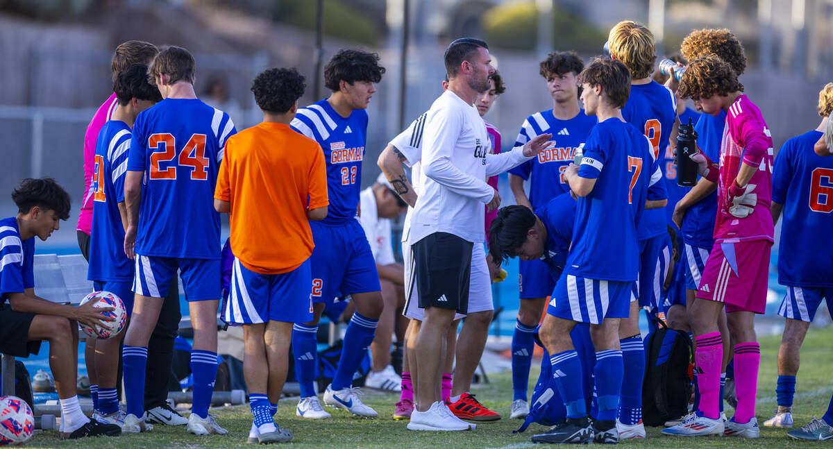 Bishop Gorman head coach Victor "Boomer" Arbelaez counsels his players during a timeo ...