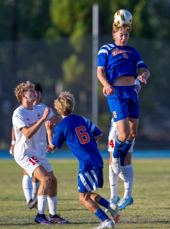 Bishop Gorman forward Chase Stewart (9) heads the ball past Coronado defender Ben Aronow (15) a ...