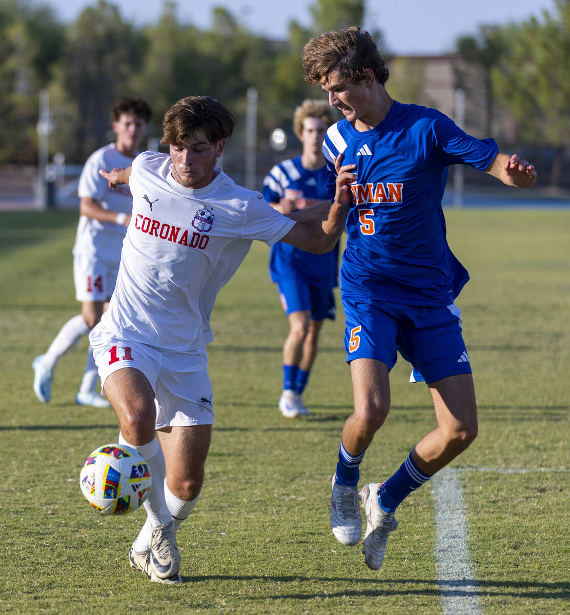 Coronado striker Gavin Flickinger (11) battles for control of the ball with Bishop Gorman midfi ...