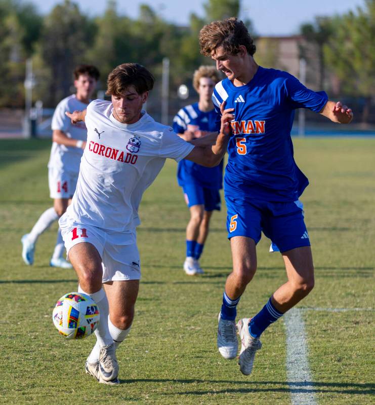 Coronado striker Gavin Flickinger (11) battles for control of the ball with Bishop Gorman midfi ...