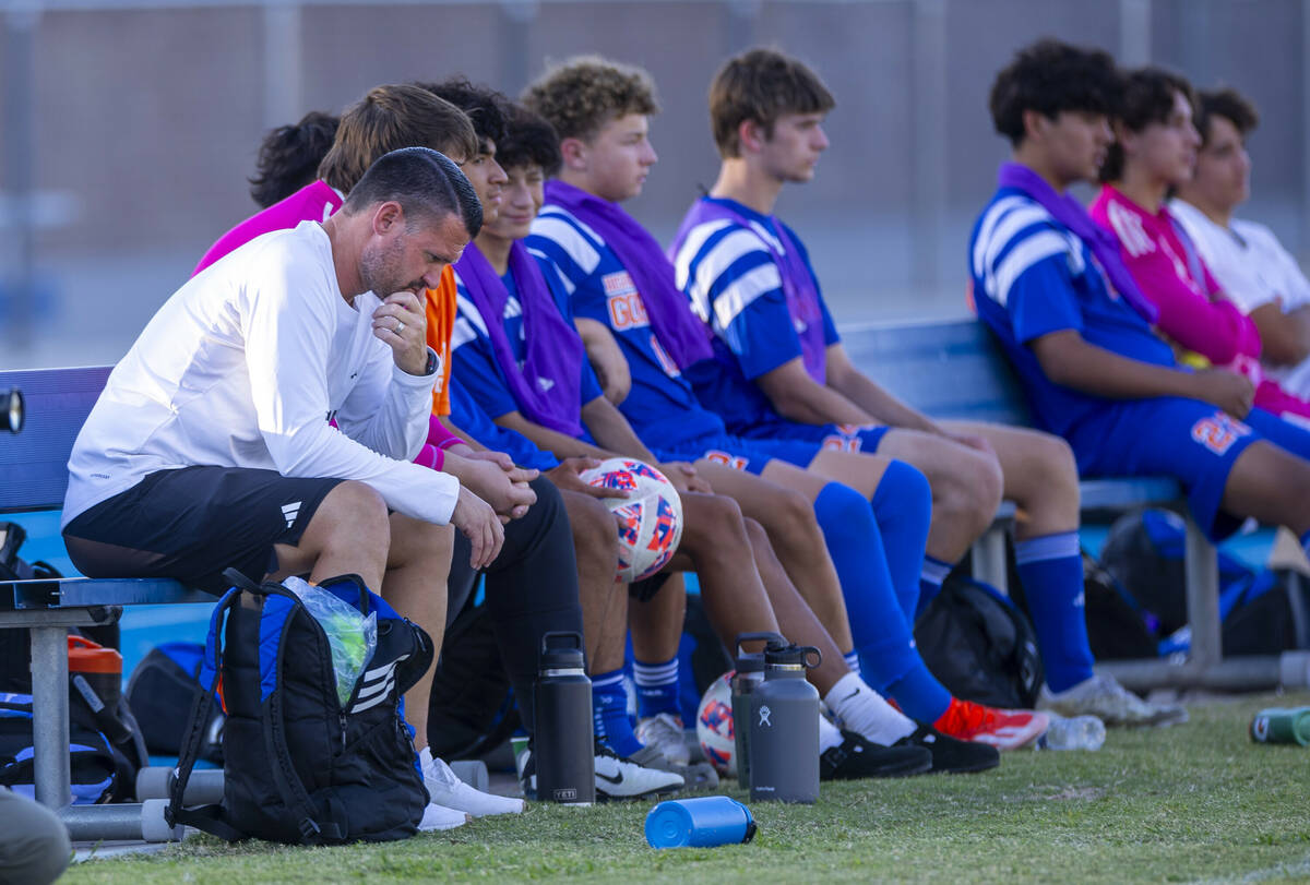 Bishop Gorman head coach Victor "Boomer" Arbelaez sits dejected on the bench as Coron ...