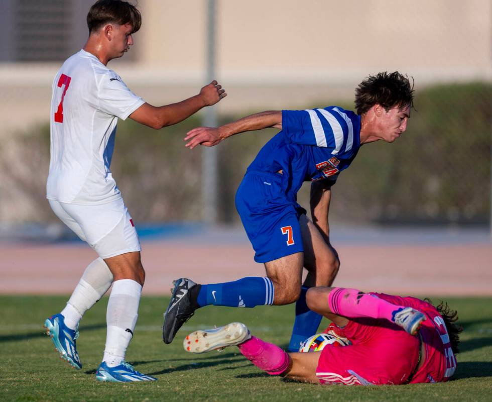 Bishop Gorman goalkeeper Chase Cosenza (99) dives on a shot by Coronado forward Austin Kiernan ...